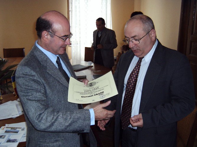 Giovanni Grano getting honorary title from the Brasov University Directory Ion Visa